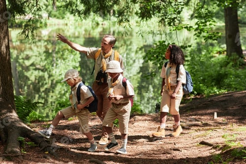 Preview: Side view at diverse group of scouts hiking