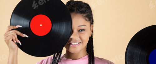 Preview: pretty young woman covering her eye with a classic musical vinyl