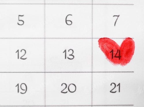 Preview: Valentine's day marked with red fingerprints on calendar sheet, top view
