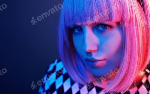 Preview: Portrait of young girl with blond hair in red and blue neon in studio