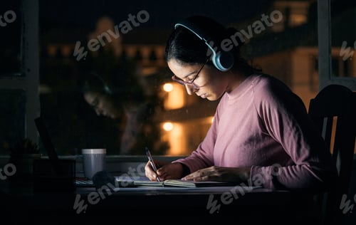 Preview: Headphones, writing and student studying at night for a test, exam or college assignment. Universit