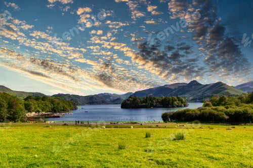 Preview: Greeny shoreline of Derwentwater lake under a cloudy sky