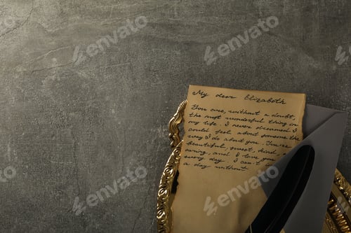 Preview: Vintage letter with text, envelope and feather on golden tray on gray background, space for text