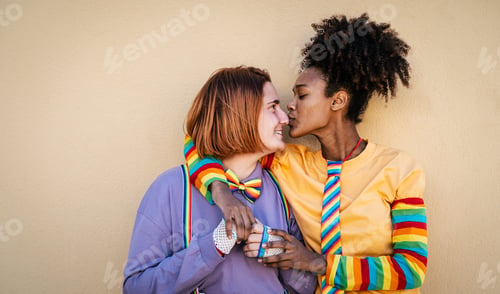 Preview: Multiracial lesbian couple celebrating gay pride day - Lgbt and love relationship concept