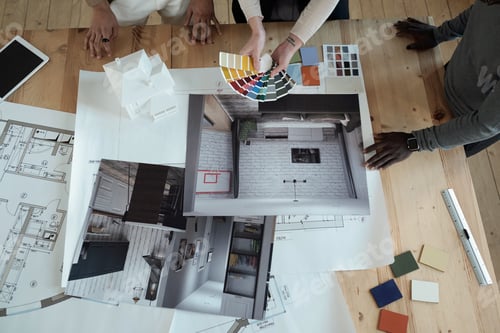 Preview: Hands of female designer with color swatches and her two male colleagues