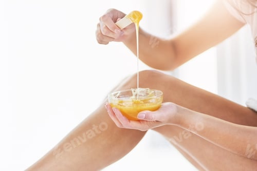 Preview: Closeup shot of an unrecognizable woman waxing her legs in the bathroom at home