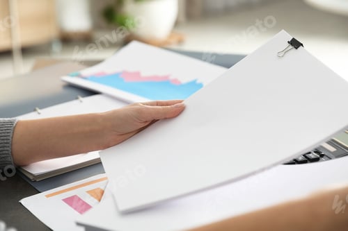Preview: Office employee working with documents at table, closeup. Space for text