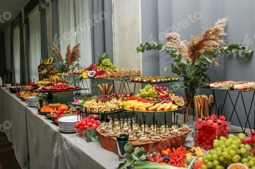 Preview: catering buffet table with snacks and appetizers. Set of varios fruits and berries. Decorative vase