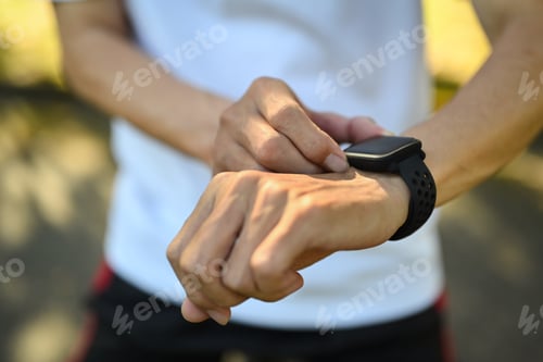 Preview: Closeup sporty senior man checking performance or heart rate pulse trace on smartwatch.