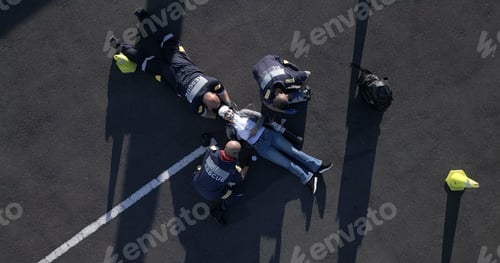 Preview: Healthcare, emergency and first aid with paramedic team on street from above for medical treatment.