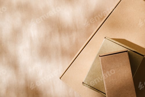 Preview: Stacked cardboard boxes on a neutral background in a shipping or packaging setting