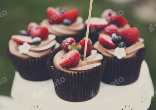 Preview: Delicious cupcakes topped with fresh strawberries and blueberries