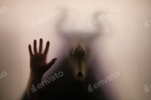 Preview: Horror, halloween background - Shadowy figure with horns behind the glass