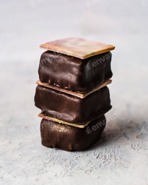 Preview: Pyramid of three chocolates on a gray background
