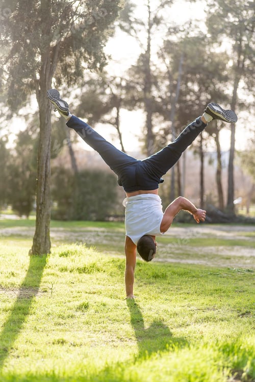 Preview: Gymnastic man handstand on one hand doing acrobatic posture