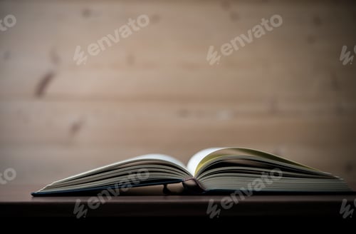 Preview: Close up of opened book on wooden table. Education concept.