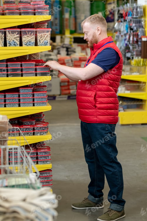 Preview: Young man choosing nails in hardware store