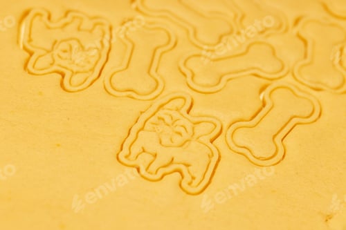 Preview: Carved cookies on a sheet of dough in the shape of a dog and bones