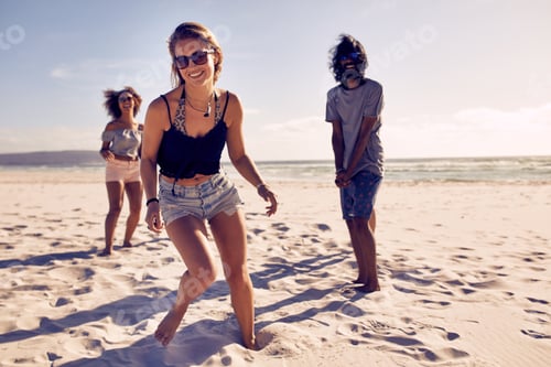Preview: Beautiful woman enjoying on the beach with friends