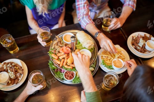 Preview: friends eating and drinking at bar or pub