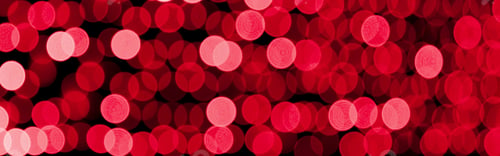 Preview: Unfocused abstract red bokeh on black background. defocused and blurred many round light