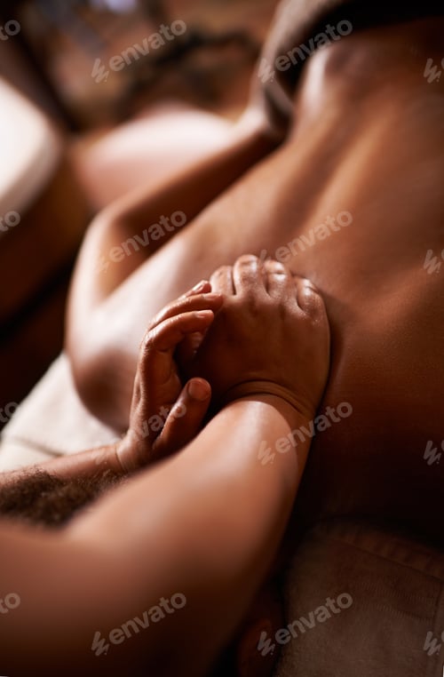 Preview: Work it. Shot of a massage therapist giving a woman a massage at a day spa.