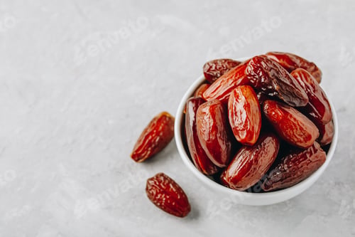 Preview: Dried dates in white bowl on grey background