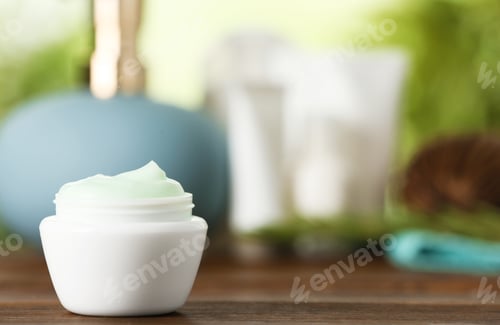 Preview: Jar of body care product on table against blurred background. Space for text
