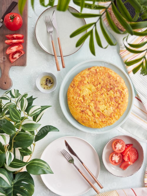Preview: Delicious whole Spanish potato omelet served on the table