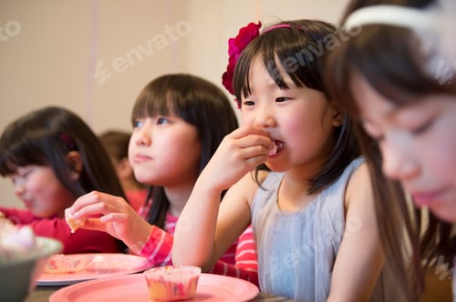 Preview: Girl's eating fairy cakes at party