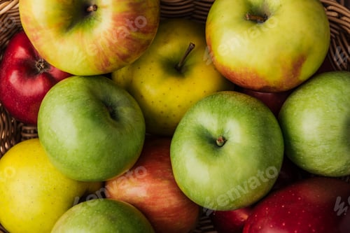 Preview: close up view of ripe multicolored apples in wicker basket