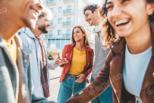 Preview: Happy multiracial friends having fun together walking on city street