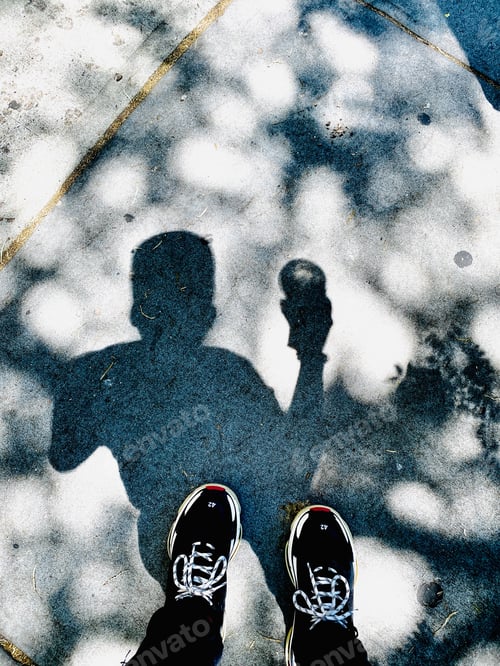 Preview: Shadow of a man walking in the city