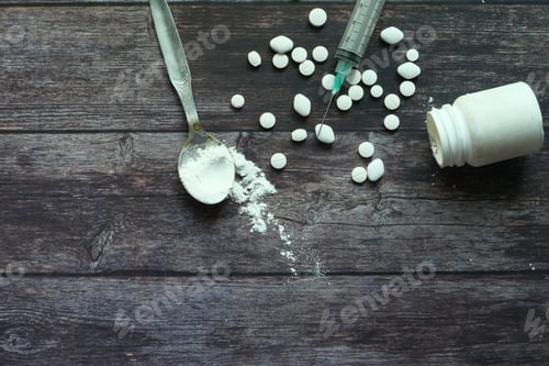 Preview: Heroine, syringe and pills on wooden background.