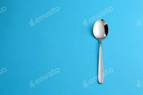Preview: Clean empty table spoon on blue background, top view. Space for text