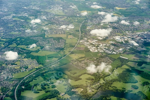Preview: Aerial view of green fields and motorway, England, UK