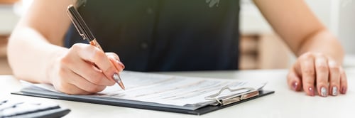 Preview: Adult Woman Filling Out Paperwork in an Office