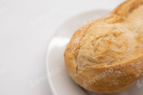 Preview: appetizing freshly baked bread on a white plate