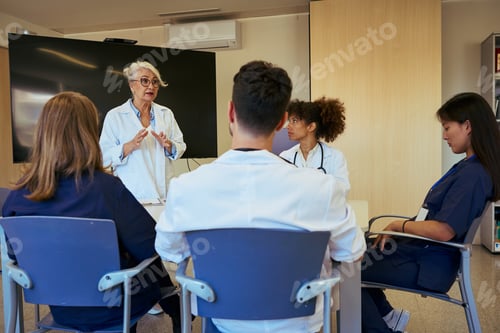 Preview: Medical team attending briefing in modern hospital conference room
