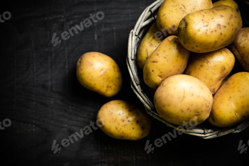 Preview: Fresh potatoes. On black background.