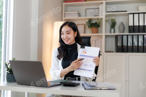 Preview: Asian businesswoman presenting financial data during online meeting