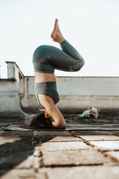 Preview: Woman Doing Yoga Outdoors On A Rooftop Terrace