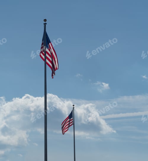 Preview: Low angle shot of the flags of the USA under a cloudy sky
