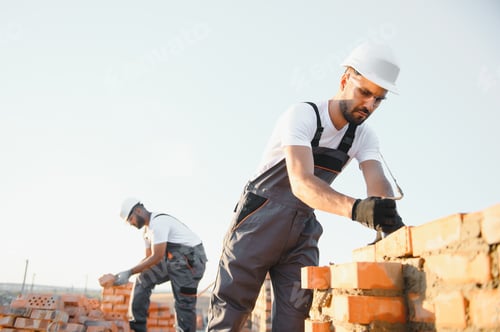 Preview: Professional construction workers build a brick house.