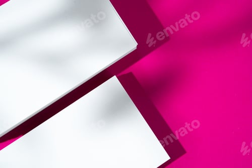 Preview: Advertising mock-up. White blank businesscards on bright pink background