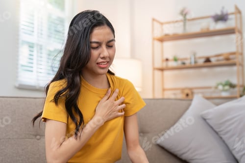 Preview: Concerned young woman dealing with chest pain