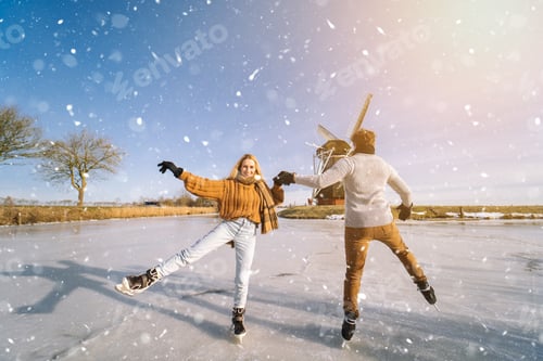 Preview: Couple Ice Skating near a Windmill in Winter