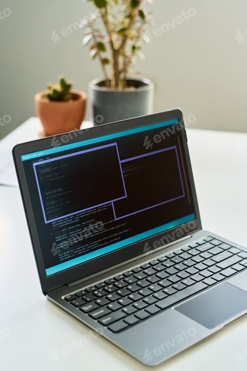 Preview: Laptop Displaying Neural Network Development Code Running on Screen Indoors