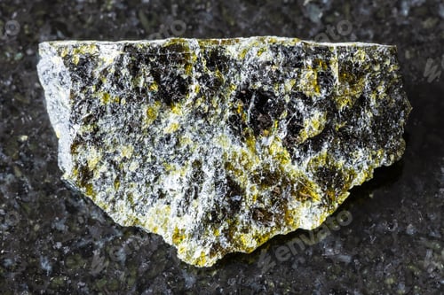 Preview: sample of rough diopside rock on black granite
