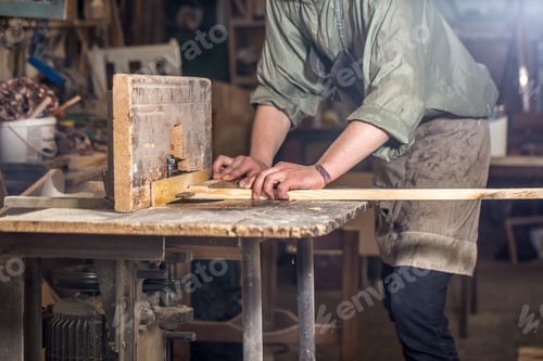 Preview: a man working with wood product on the machine